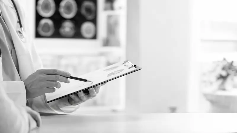 Doctor reviewing a patient chart at Summit Neurology in Burleson, TX